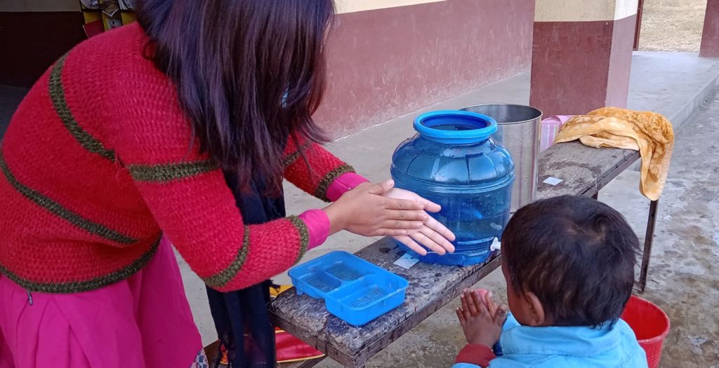 Susmita teaching hand washing, Taltuleshowry school