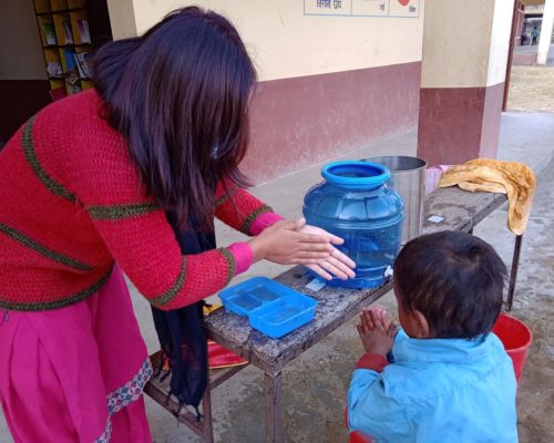 Susmita teaching hand washing, Taltuleshowry school