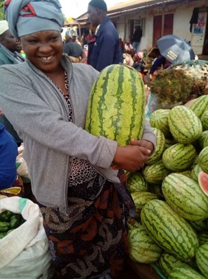 Scholastika (one of our most recent recipients) at her watermelon stall.